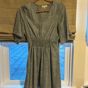 Sage green dress with white circular pattern.